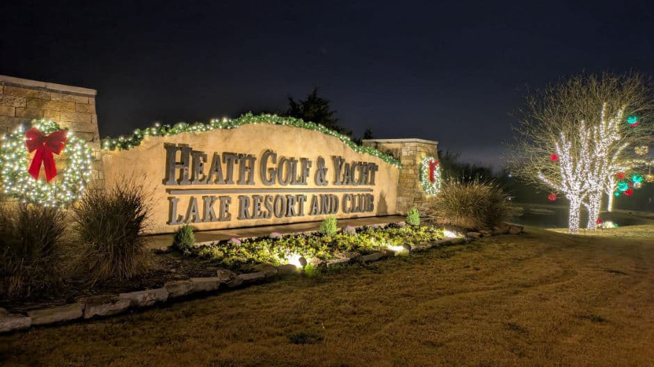 Heath Golf and Yacht Lake Resort sign lit up for the holidays, surrounded by festive decorations.