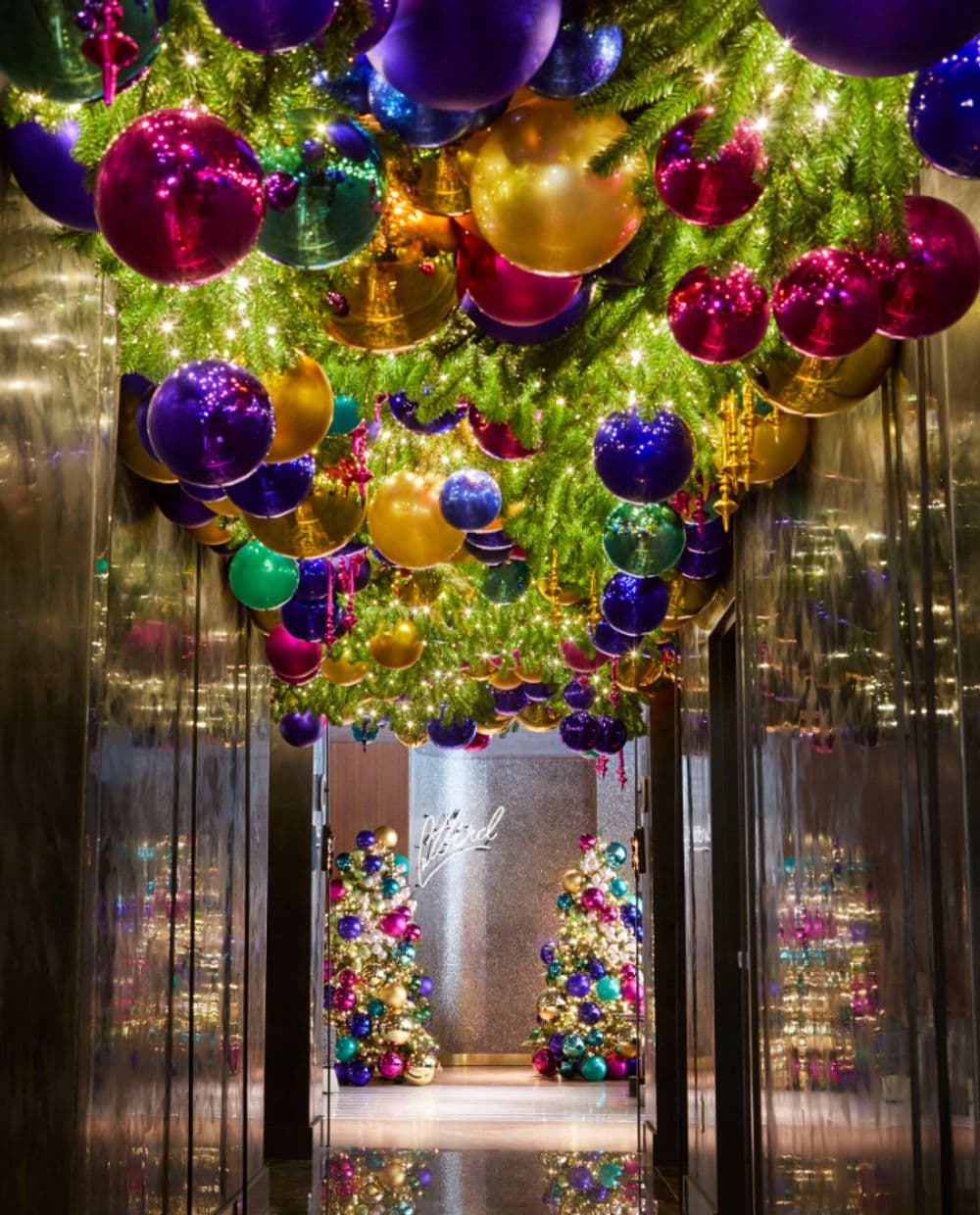 Luxurious holiday hallway adorned with colorful ornaments and festive trees.
